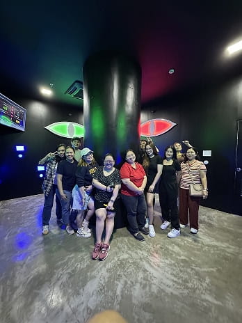 A group posing together in the Devil's Eyes room at INMERS One Ayala