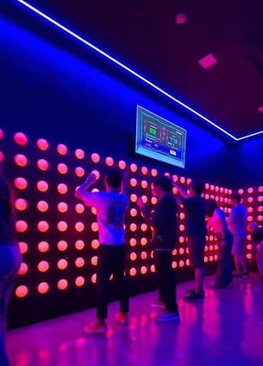 Players hitting the lit buttons in Line Line